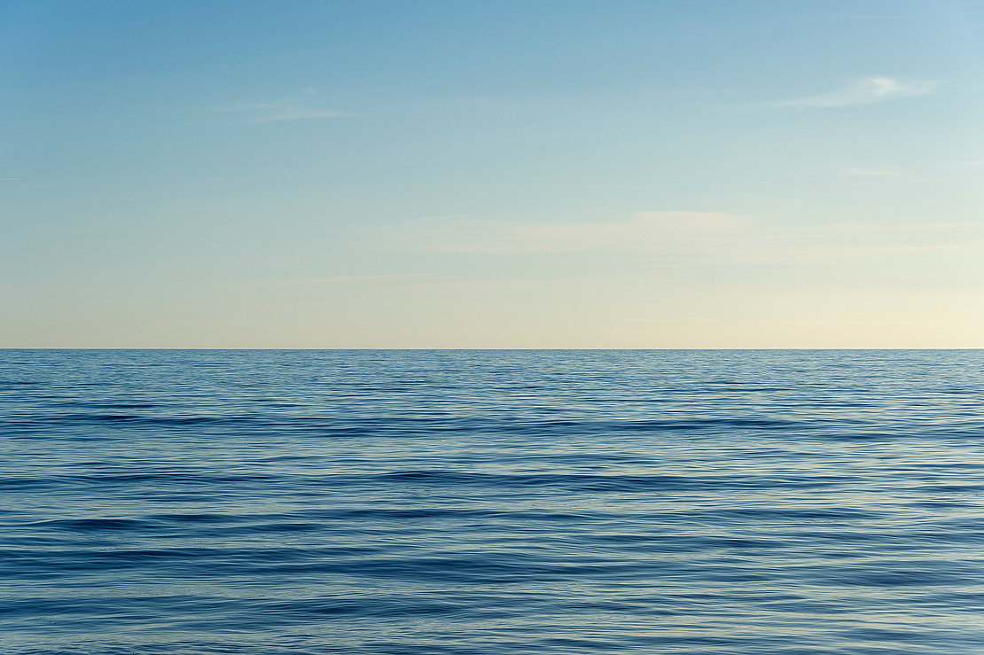 clear sky and calm sea or ocean water surface background