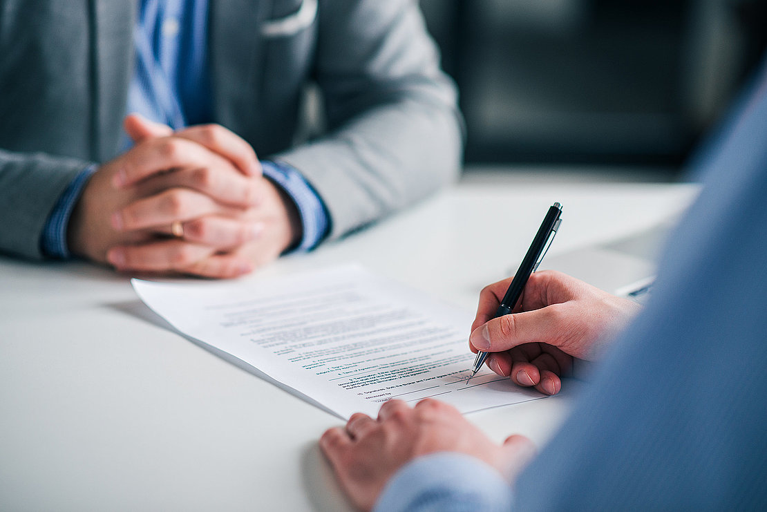 Signing contract on a meeting, close-up.