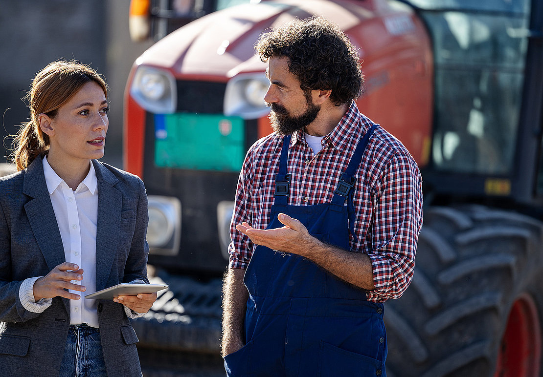 Farmer and woman discuss about business on farm