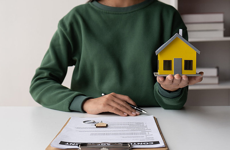 Close up view of real estate agent working with document in her office room, preparing the information for her client.