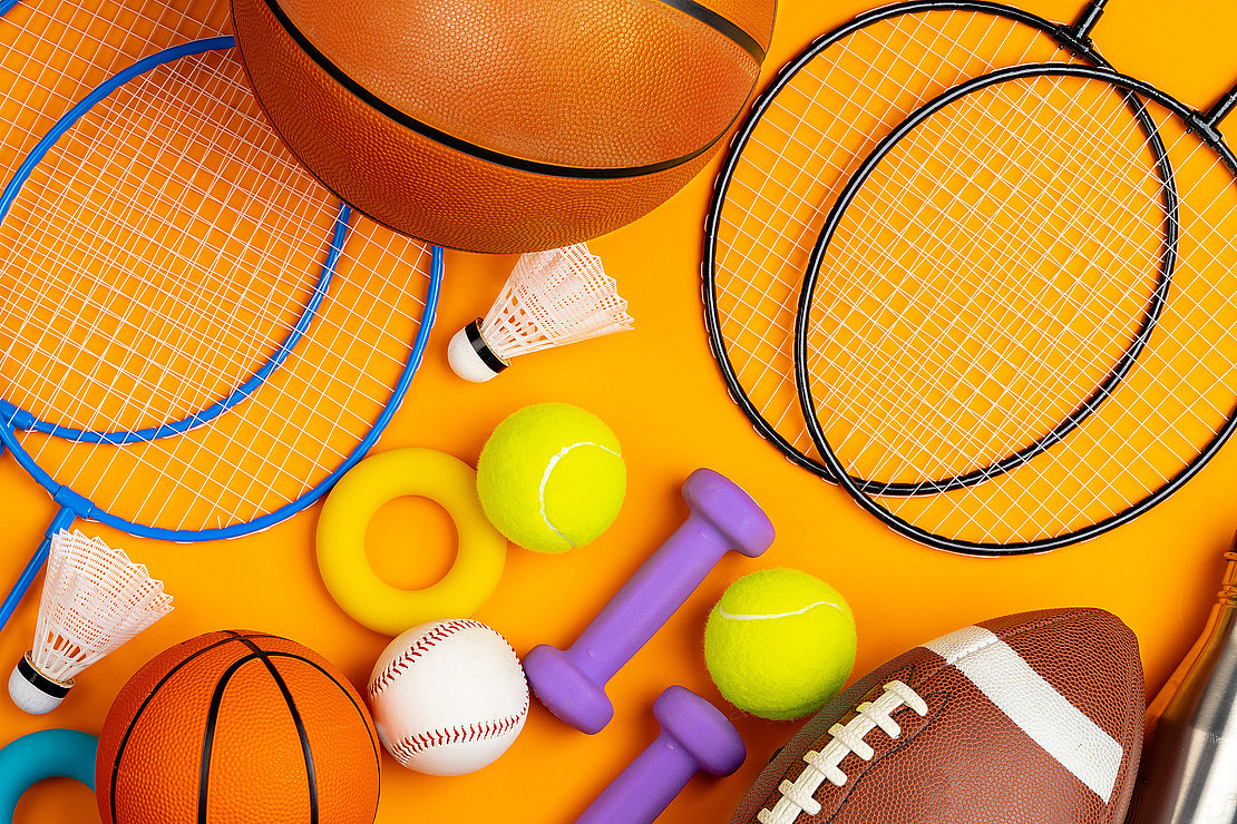 Assortment of sport equipment on yellow background, top view