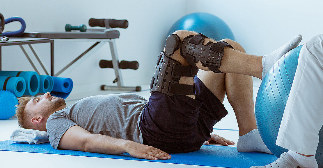 Teenage girl after car accident with orthosis on the leg exercis