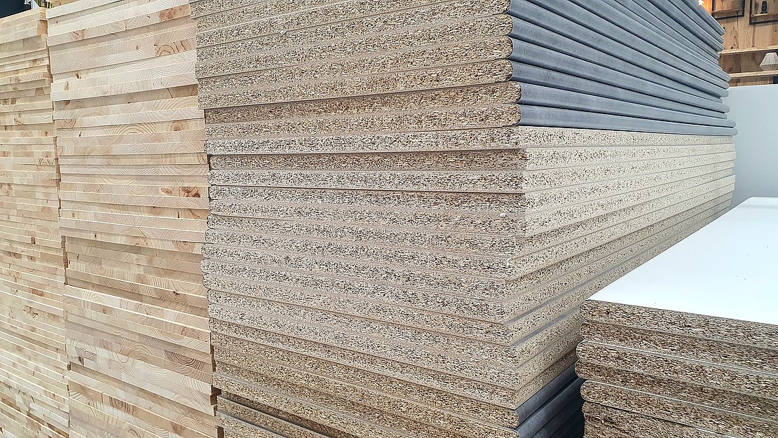 Sale and purchase of wooden chipboards in a hardware store. Construction materials for furniture and repairs. Wooden slabs Chipboard stack, interior design, handmade furniture. Wood products, lumber.