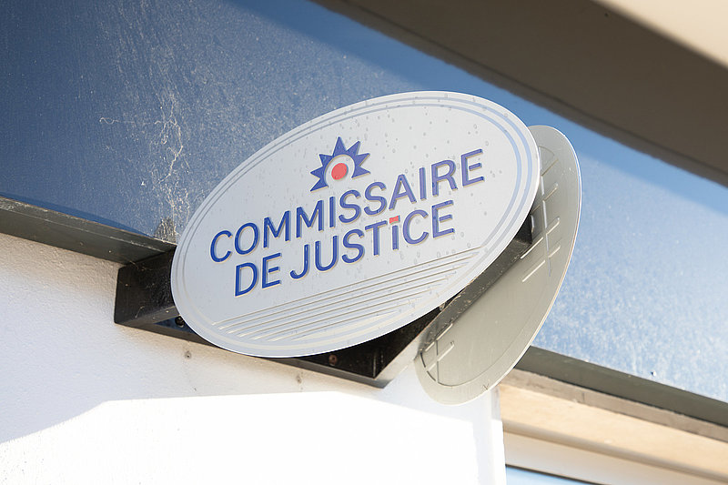 Commissaire de justice logo brand and text sign facade in france means office bailiff in French on wall entrance
